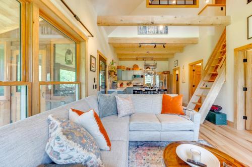 a living room with a couch and a table at Fire Pit and Views Pet-Friendly Vermont Cabin in Craftsbury