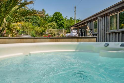 a hot tub in a backyard with a teddy bear at The Barn at Salcombe Farm, with Hot Tub and Free Parking in Salcombe