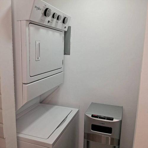 a small kitchen with a stove and a refrigerator at Pool Sensation Punta Cana in Bávaro