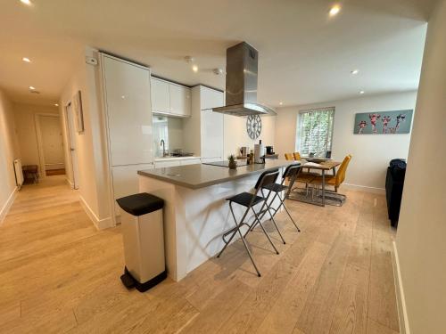 a kitchen with a island in the middle of a room at Spacious & light 2bed, 2bath in the heart of Windsor in Windsor