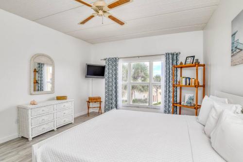 a bedroom with a white bed and a window at Pier Point 17 in St. Augustine
