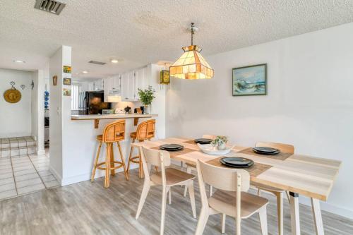 a kitchen and dining room with a table and chairs at Pier Point 17 in St. Augustine