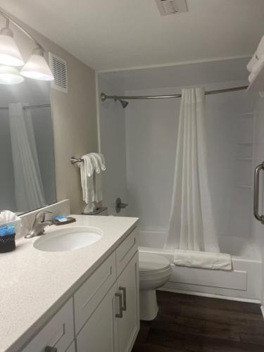 a bathroom with a sink and a toilet and a shower at Summer Sands - 304 by Sea Scape Properties in Wrightsville Beach