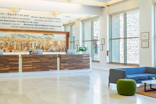 a lobby with a large painting on the wall at Domus Pacis Assisi in Assisi