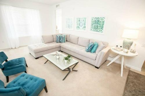 a living room with a couch and a table at Modern Vacation Apartment with a Lake View in Orlando