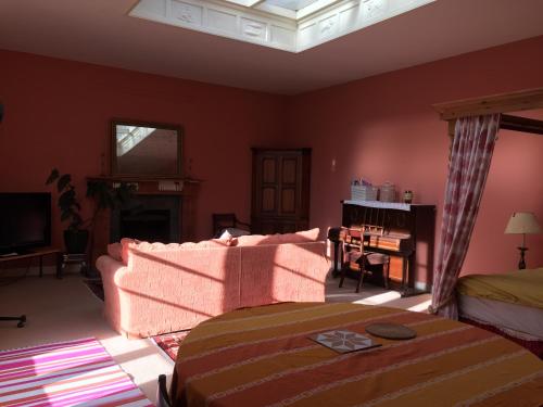 a living room with a couch and a bed at Gilchristland Organic Farm Retreat in Closeburn
