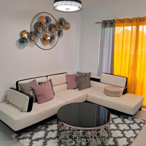 a living room with a couch and a table at Pool Sensation Punta Cana in Bávaro