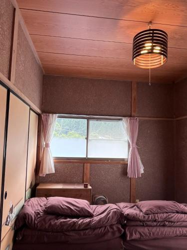 a bedroom with a bed in front of a window at Tonegun - House - Vacation STAY 17721 in Kawaba