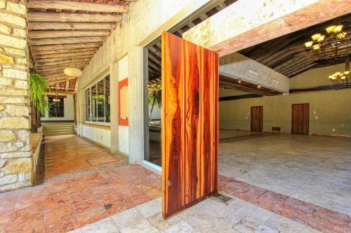 a wooden door in the middle of a building at Hotel Ciudad Real Palenque in Palenque