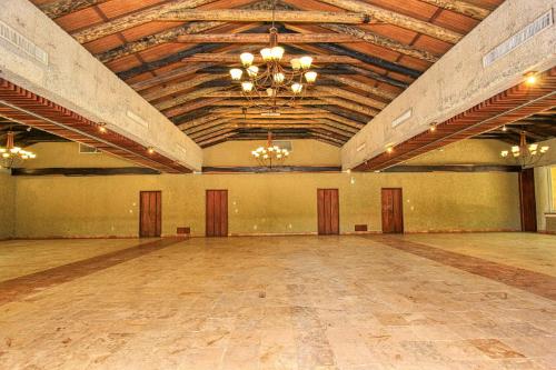 a large room with a dance floor with a chandelier at Hotel Ciudad Real Palenque in Palenque