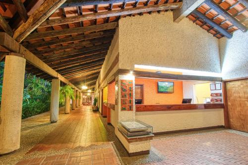 an empty hallway of a building with a wooden ceiling at Hotel Ciudad Real Palenque in Palenque