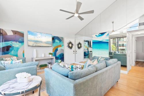 a living room with blue couches and a ceiling fan at Beach Rd, 300ft to Beach Access & 500ft to Siesta Key Village, 2bdr & Studio in Siesta Key