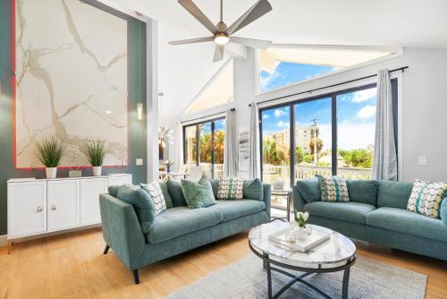 a living room with two couches and a table at Beach Rd, 300ft to Beach Access & 500ft to Siesta Key Village, 2bdr & Studio in Siesta Key