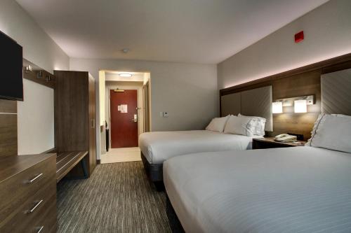 a hotel room with two beds and a television at Holiday Inn Express Durham-UNH by IHG in Durham