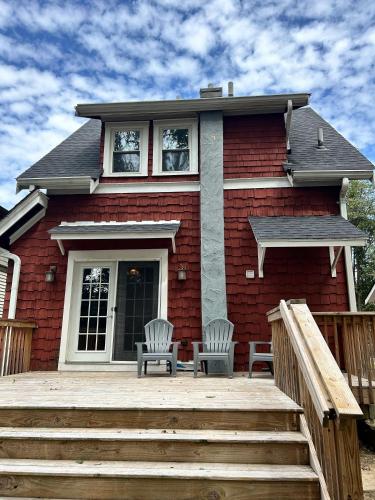 a house with two chairs on a wooden deck at Palmetto 2 Bed Family House in Cincy near Hyde Park in Cincinnati