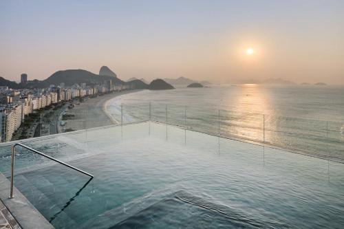 a swimming pool with a view of the ocean at Rio Othon Palace in Rio de Janeiro