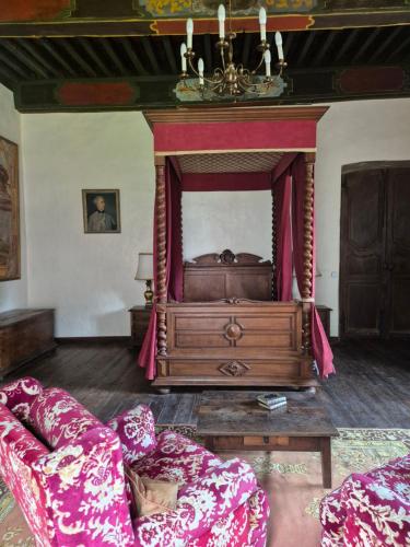 a living room with a bed and a couch at Chateau de Presque in Saint-Médard-de-Presque