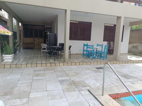 a house with a patio with a table and chairs at Rô Hostel Cabo Branco in João Pessoa