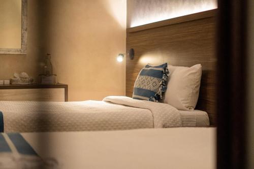 a bedroom with a bed with a pillow on it at Hotel Casona Oaxaca in Oaxaca City