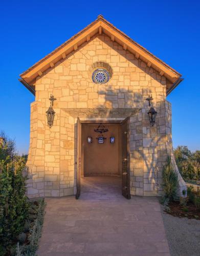 a large stone building with a large door at Allegretto Vineyard Resort Paso Robles in Paso Robles
