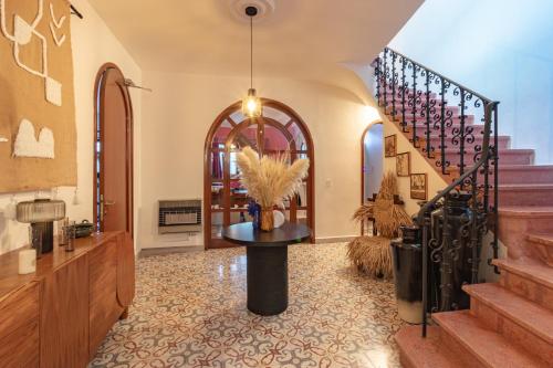 a hallway with a staircase with a table with a plant at Nokal Exclusive Stay in Mexico City