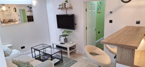 a living room with a couch and a table at NEW 3 bedrooms Flat in Ashford near Heathrow in Ashford