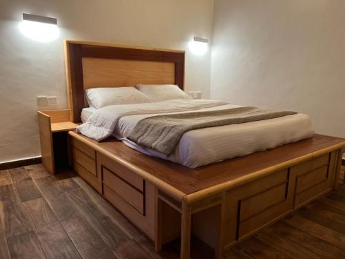 a bedroom with a large bed on a wooden platform at Fly Fishes Hotel in Saint-Louis