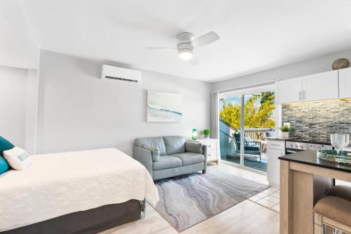 a bedroom with a bed and a couch and a kitchen at Beach Rd, 300ft to Beach Access & 500ft to Siesta Key Village, 2bdr & Studio in Siesta Key