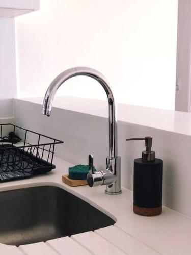 a kitchen sink with a faucet next to a sink at Apartment with Panoramic & Ocean View in Lima