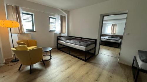 a living room with a couch and a mirror at Family Apartments Černice in Mojné
