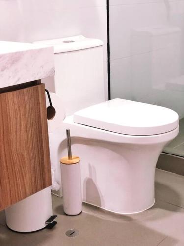 a bathroom with a white toilet and a sink at Apartment with Panoramic & Ocean View in Lima