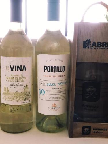 two bottles of wine sitting on a table at Apartment with Panoramic & Ocean View in Lima