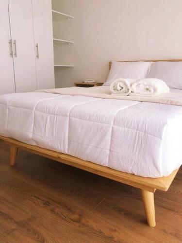 a bed with white sheets and towels on it at Apartment with Panoramic & Ocean View in Lima