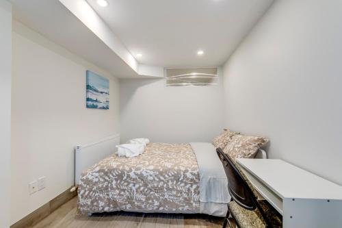 a bedroom with a bed and a desk at Midtown 2 Bedroom Apartment in Toronto