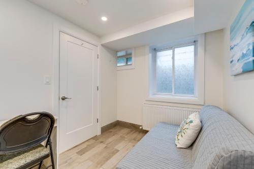 a living room with a couch and a window at Midtown 2 Bedroom Apartment in Toronto