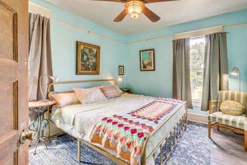 a bedroom with a bed and a fan and a window at about 3 Mi to Dtwn Centrally Located Birmingham Home! in Birmingham