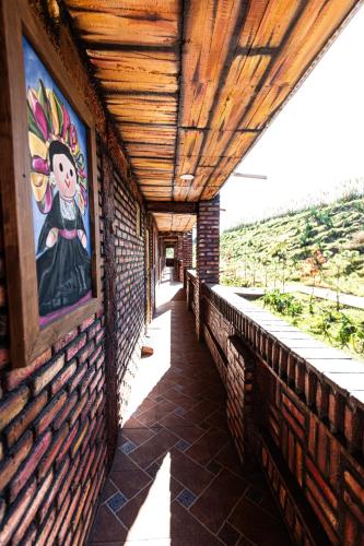 a painting on the side of a brick building at HOTEL & SPA LOS AGAVES Tepotzotlán in Las Ánimas