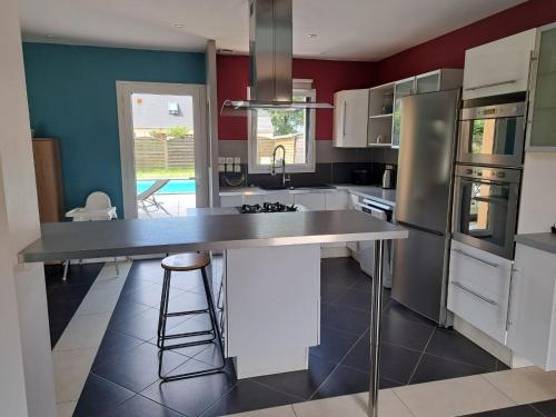 a kitchen with a large island in the middle at Robin in Saint-Aubin-des-Châteaux