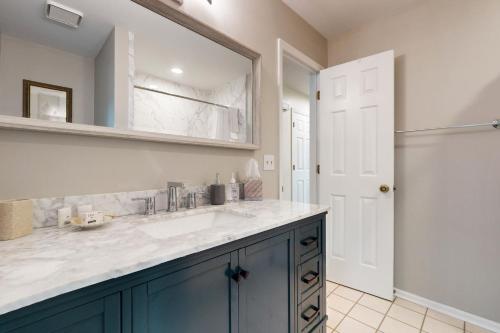 a bathroom with a sink and a mirror at Clubhouse Villa 2BR in Sunset Beach