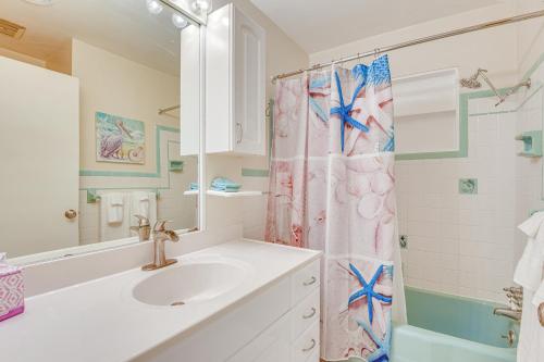 a bathroom with a sink and a shower curtain at Mins from Anna Maria Island Bright Home with Pool! in Bradenton