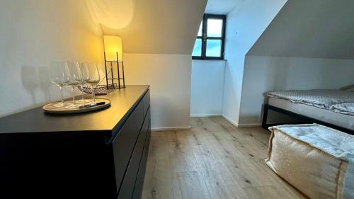 a room with a table with wine glasses on it at Family Apartments Černice in Mojné