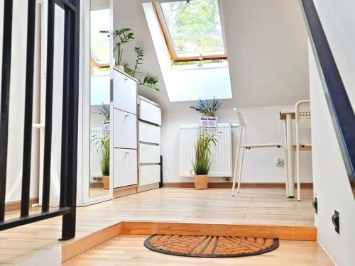 a home with a skylight and plants at Pokoje po drodze w Barczewie in Barczewo