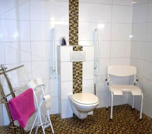 a bathroom with a toilet and two chairs in it at Tranquil Retreat in Hamoir, Belgium - Perfect for Families Friends in Hamoir