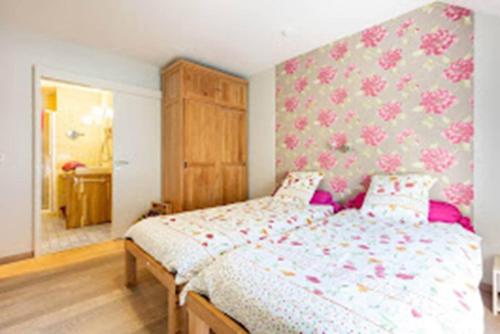 a bedroom with a large bed with pink and white sheets at Tranquil Retreat in Hamoir, Belgium - Perfect for Families Friends in Hamoir