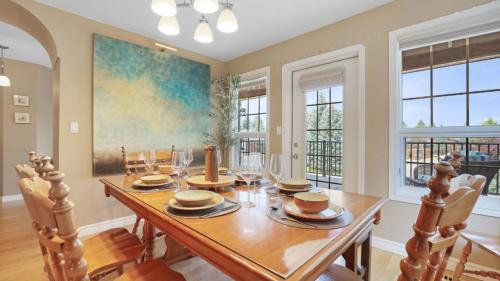 a dining room with a table and chairs and windows at Marble Canyon in Fairmont Hot Springs