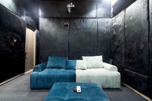 a living room with a couch and a blue sofa at Elegant 3 Bedroom Terrace Duplex in Lekki in Ikate