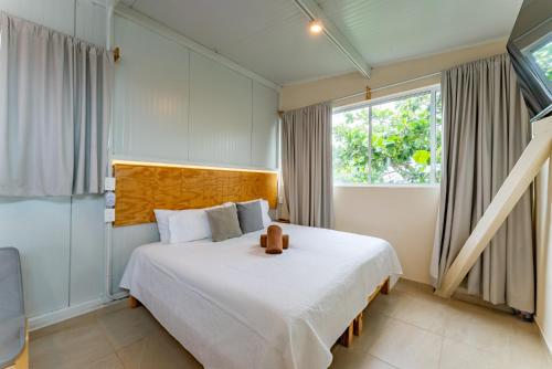 a bedroom with a bed with a teddy bear on it at Casa Jicama in Cancún