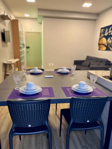 a table with chairs and plates on it in a living room at LK Santo Agostinho 4 in Belo Horizonte
