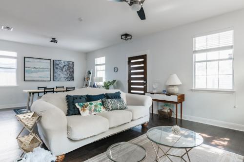 a living room with a white couch and a table at Modern 2-Story Cowboy Pool Gem with King Beds in East DT Walk to lake, La BBQ in Austin