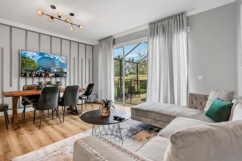 a living room with a couch and a table at 3BD/3BA Windsor Hills, 10 min to Disney in Orlando